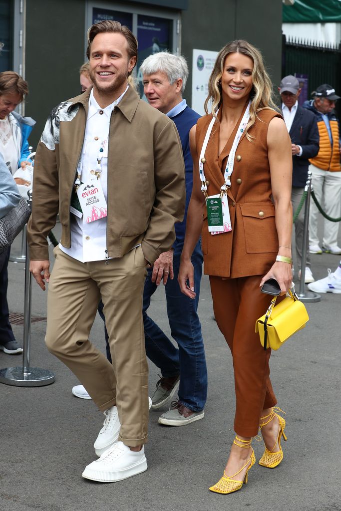 Olly Murs in a brown jacket and Amelia Tank in a brown co-ord with yellow shoes at Wimbledon