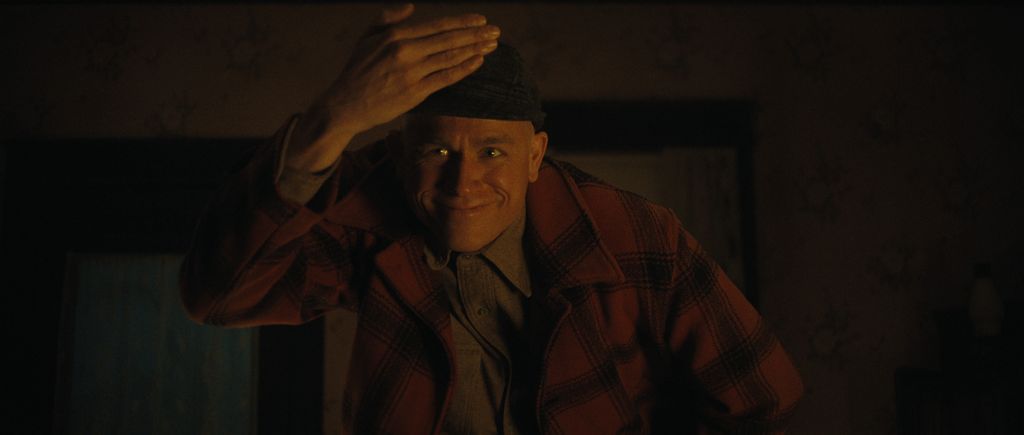 man holding hand in air in dimly lit room