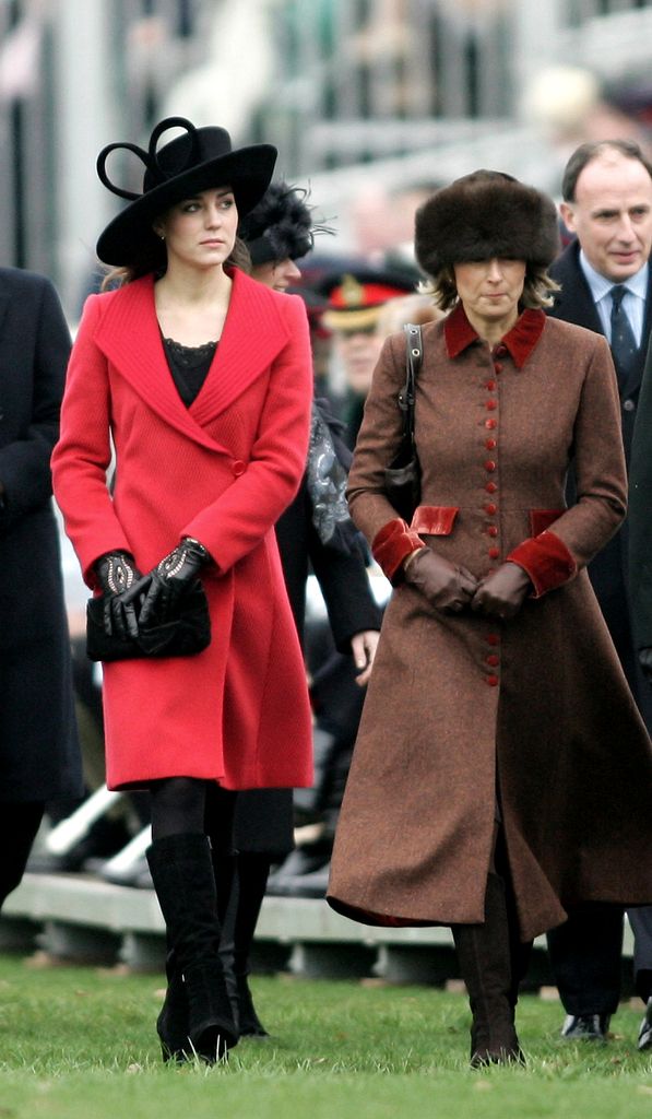 Kate Middleton in a red jacket and black hat with her mother Carole