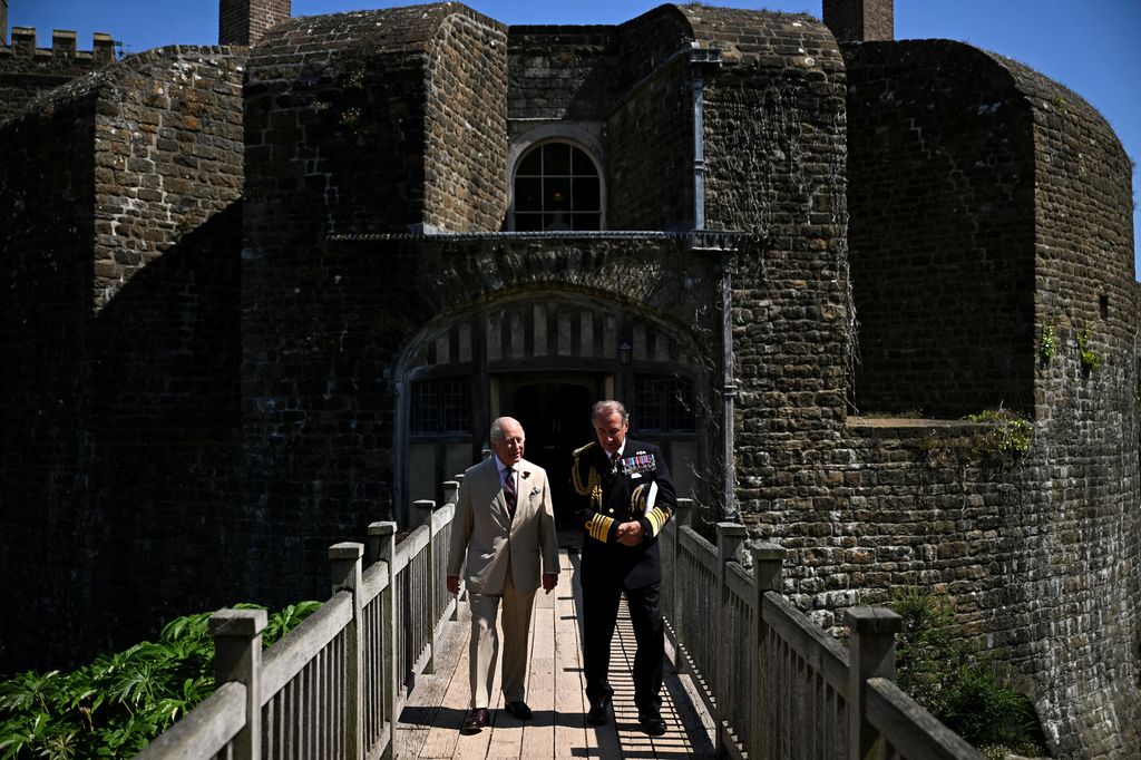 King Charles walking with Admiral George Zambellas along castle bridge