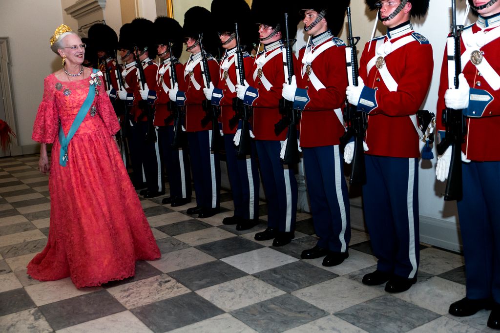 Queen Margrethe walking past royal guards