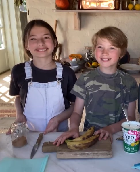 Petal and Buddy smiles as they cook together in their kitchen