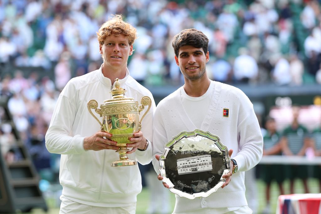 Jannik Sinner of Italy poses with the Gentlemen's Singles Trophy alongside Carlos Alcaraz of Spain with the Gentlemen's Singles Runner-Up Trophy after the Gentlemen's Singles Final on day fourteen of The Championships Wimbledon 2025 at All England Lawn Tennis and Croquet Club on July 13, 2025 in London, England