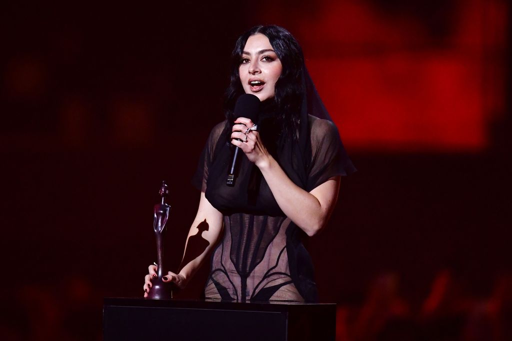 Charli XCX on stage with a BRIT Award