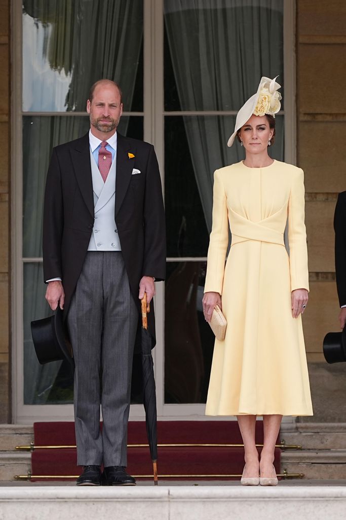 The Prince and Princess of Wales stand at the top of the Garden steps before the start of a Royal Garden Party at Buckingham Palace