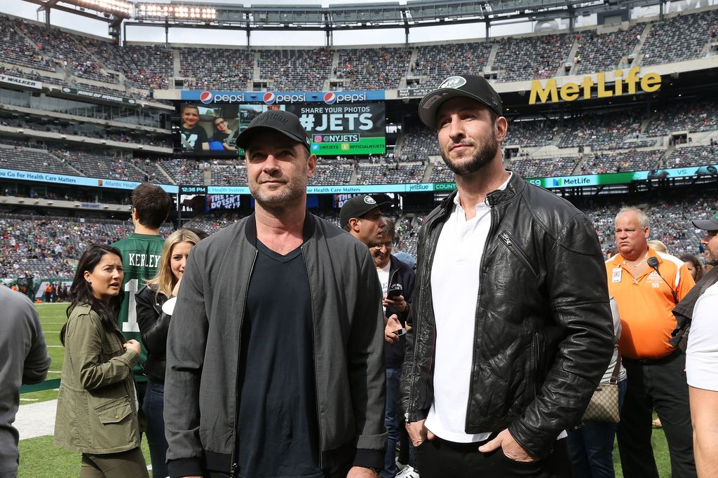 Liev Schreiber and Pablo Schreiber standing on a football pitch