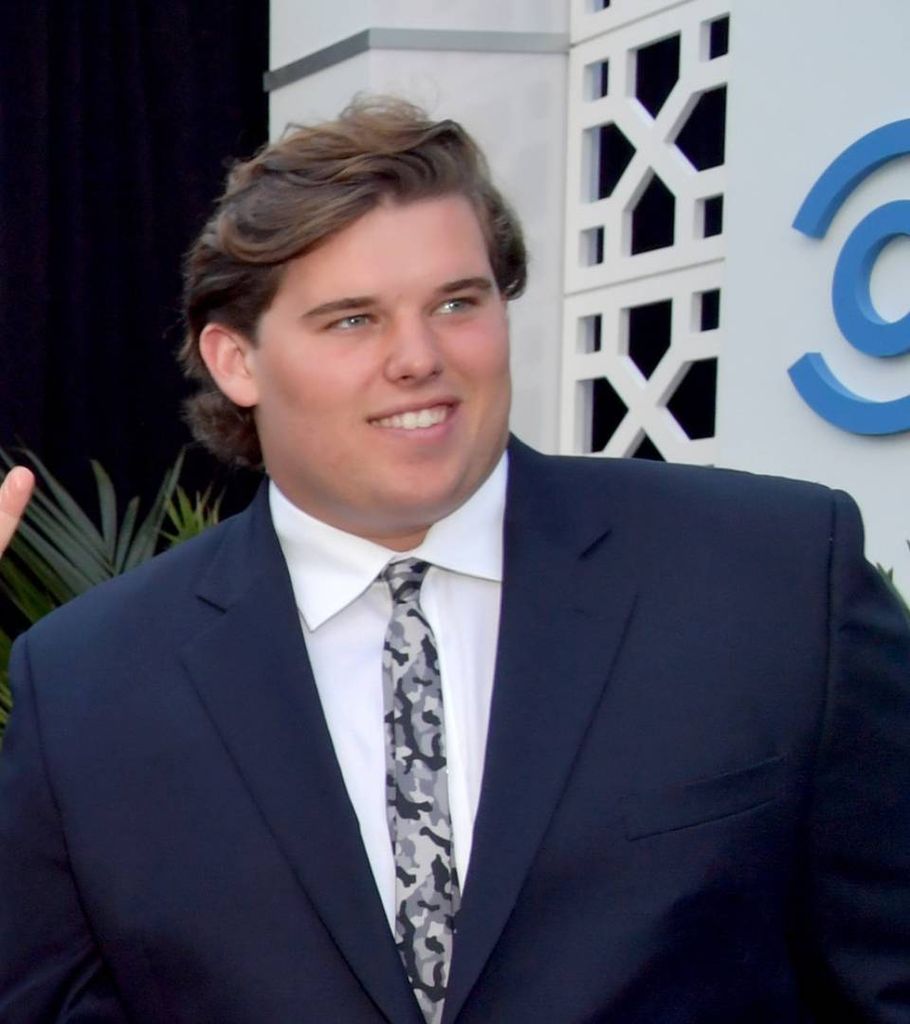 Christopher wearing suit looking larger than today