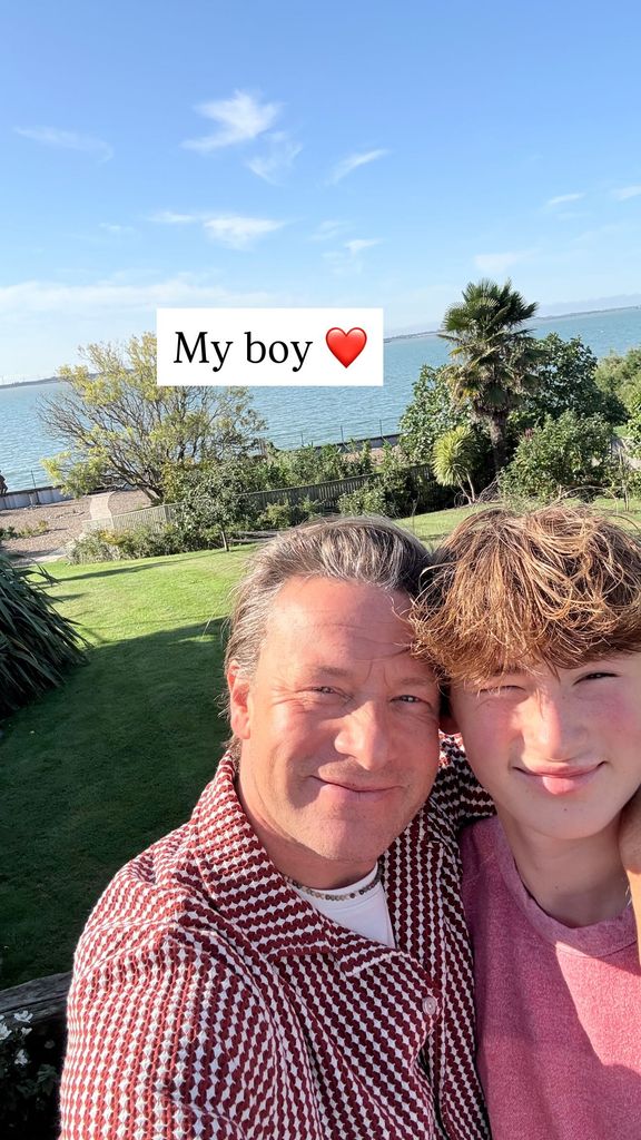 Jamie selfie with his eldest son with sea backdrop