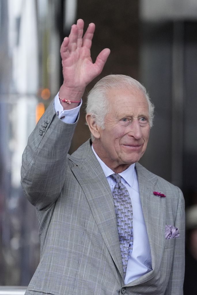 king charles waving in grey suit