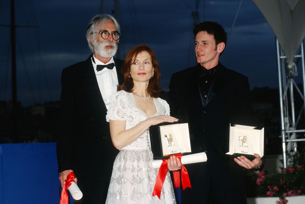 CANNES, FRANCE - MAY 2001: Awarded director Michael Haneke and awarded actors Isabelle Huppert and Benoit Magimel attends the 54th Cannes Film Festival on May 2001, in Cannes, France. (Photo by FocKan/WireImage)