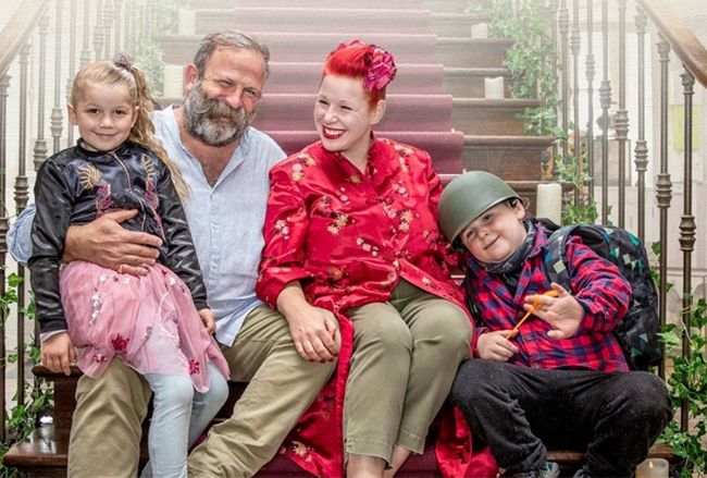 The Strawbridge family sit on the stairs at their Chateau