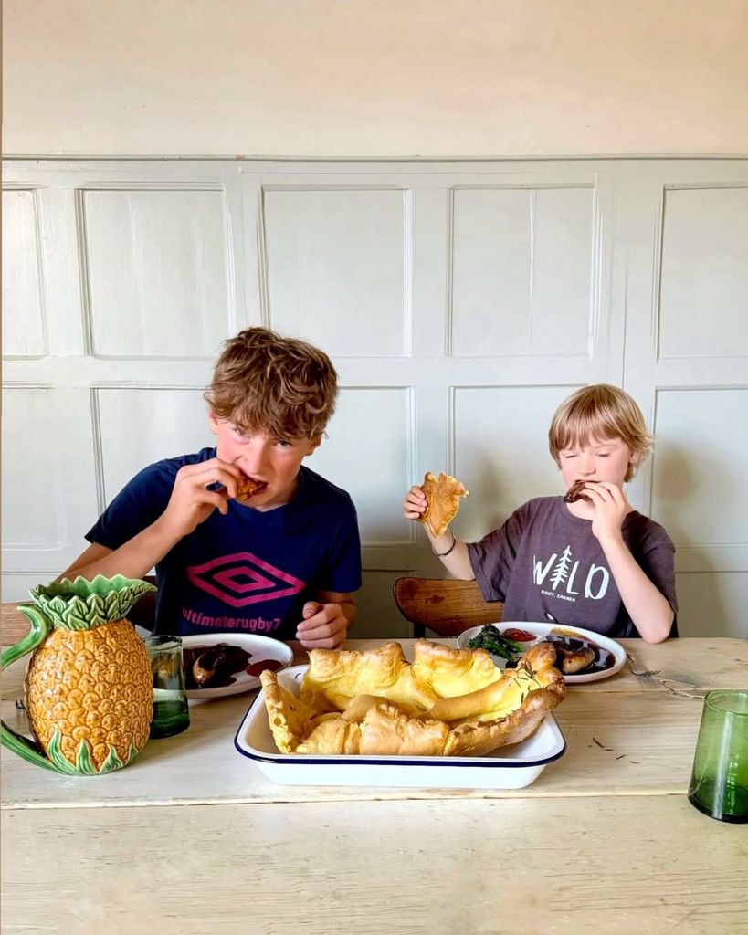 Buddy and River Oliver sitting at dining room table eating food