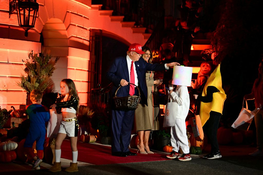 Like he did in his first term, the president placed a candy on a trick or treater's head