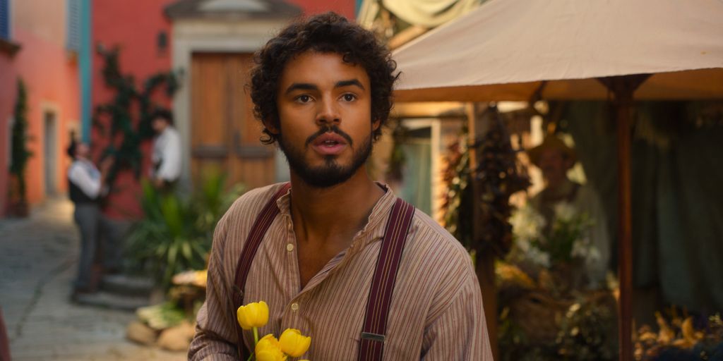 A man stands with flowers
