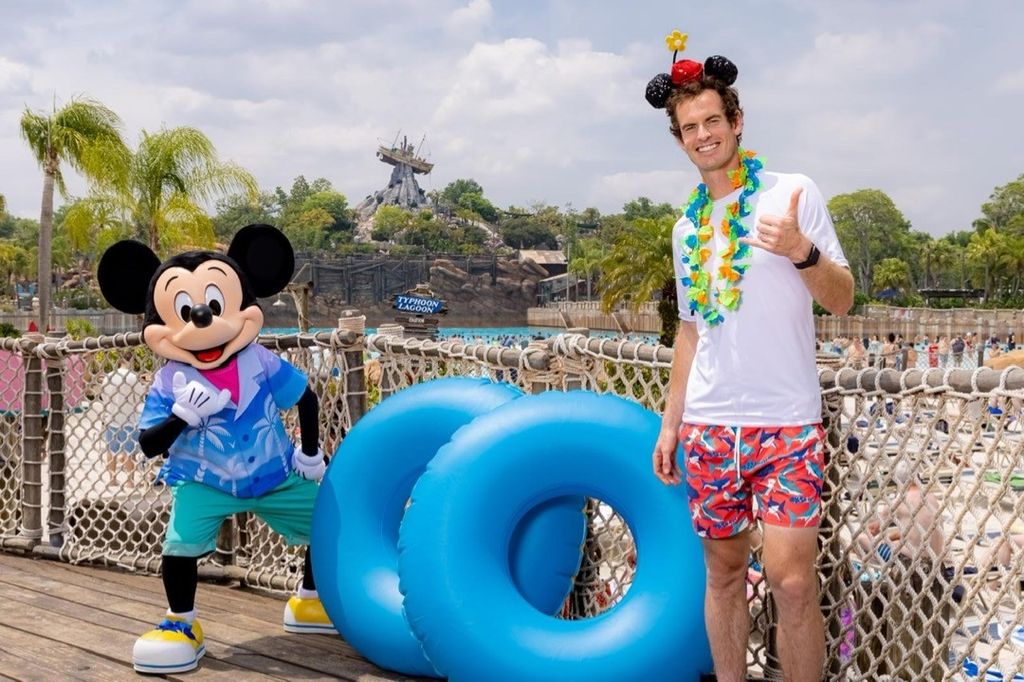 Andy posing for a photo with Mickey Mouse 