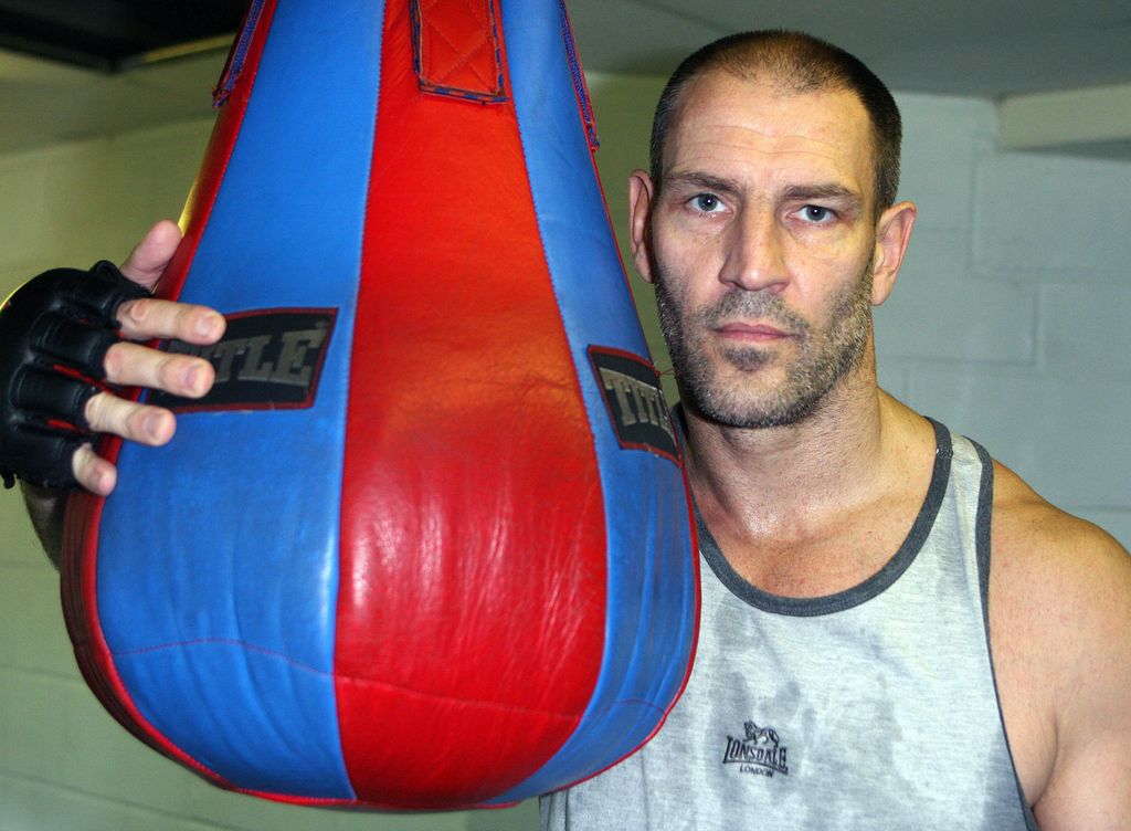 Dave Legeno in a gym in a white sports top