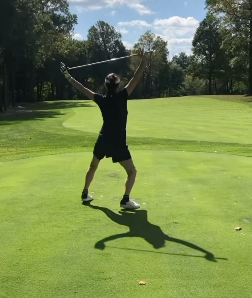 catherine zeta jones celebrating with a victory dance following a successful putt