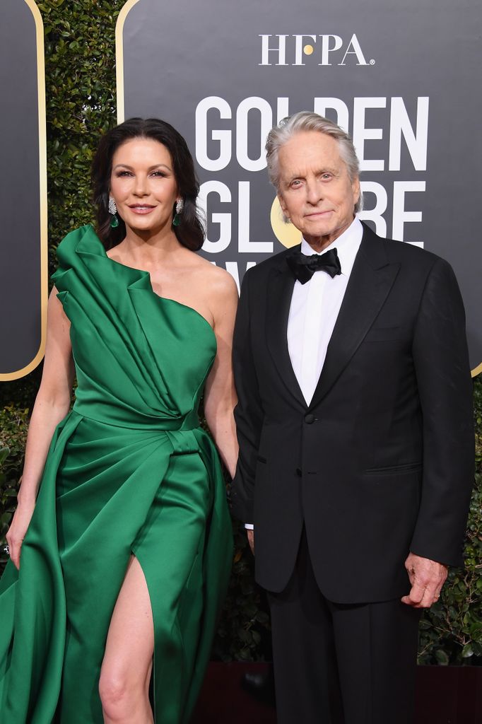 photo of catherine zeta jones in green dress and michael douglas in tux at golden globes 2019