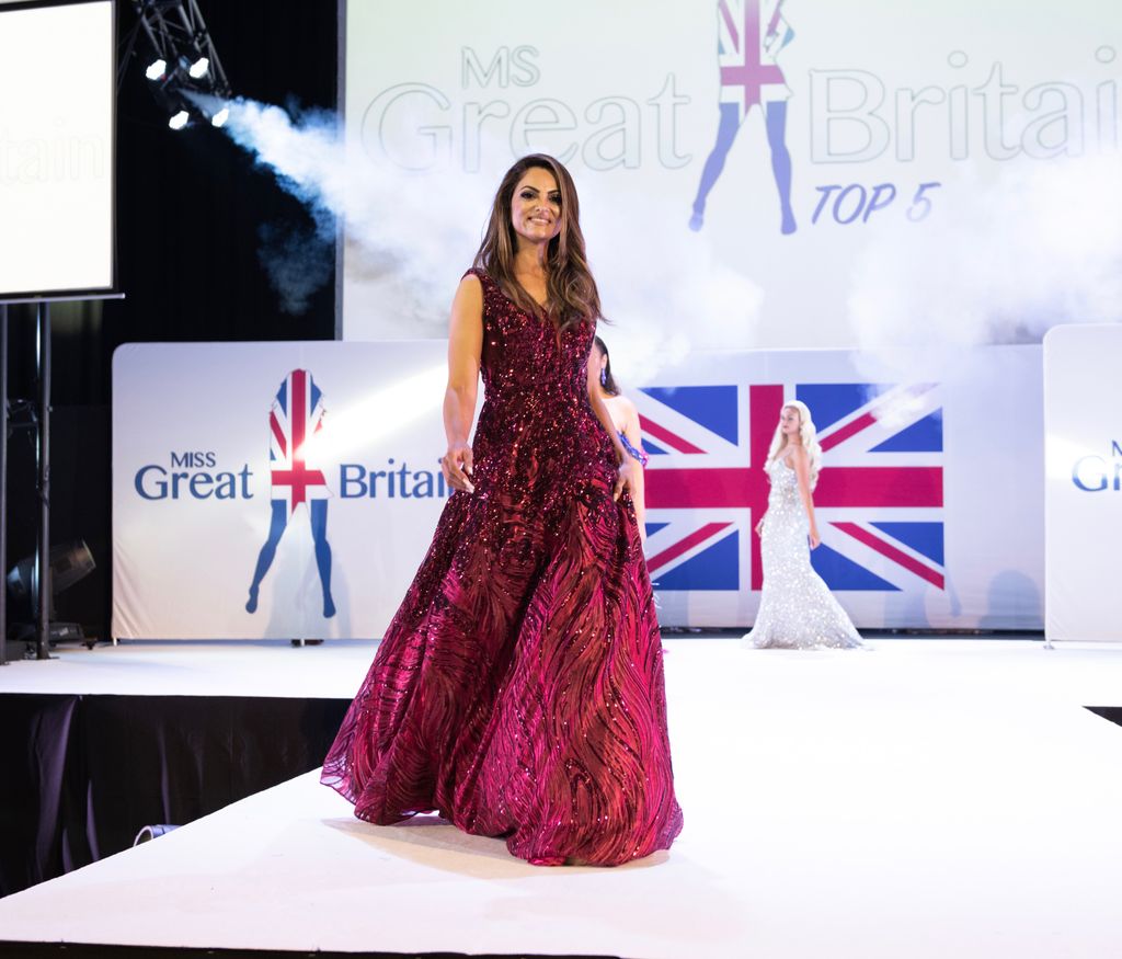 Rajni on stage in red gown during the Miss GB competition