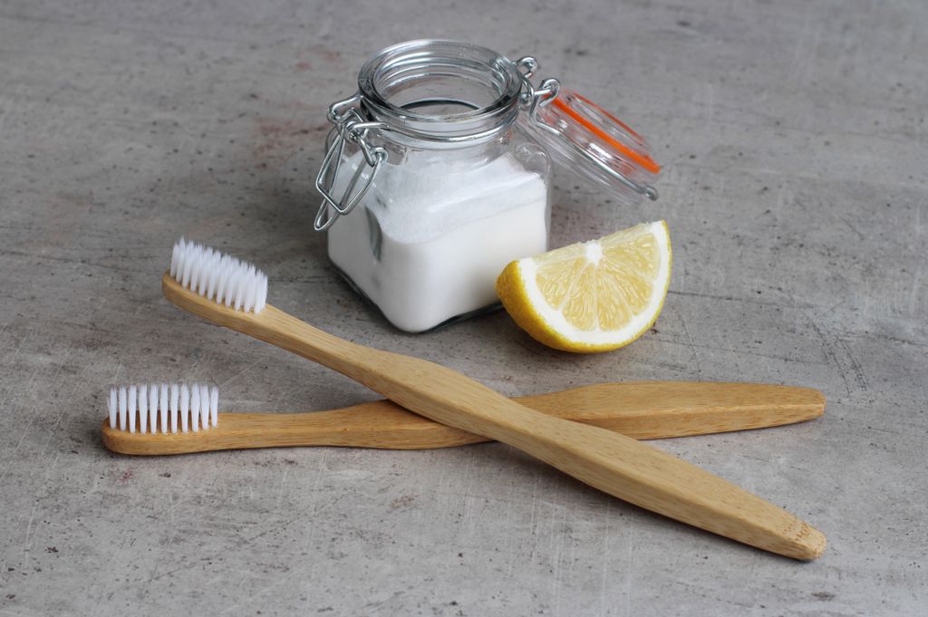 Baking powder and lemon juice with toothbrushes for cleaning