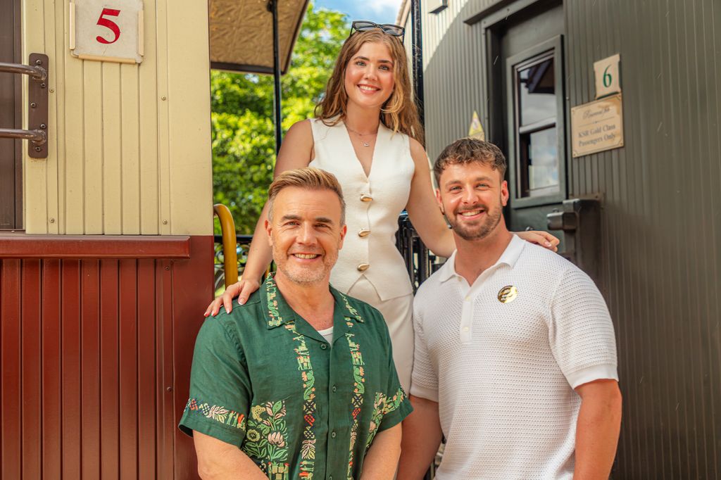 two men with woman smiling for photo