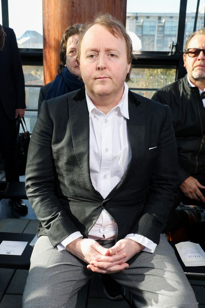 James McCartney sitting in blazer 