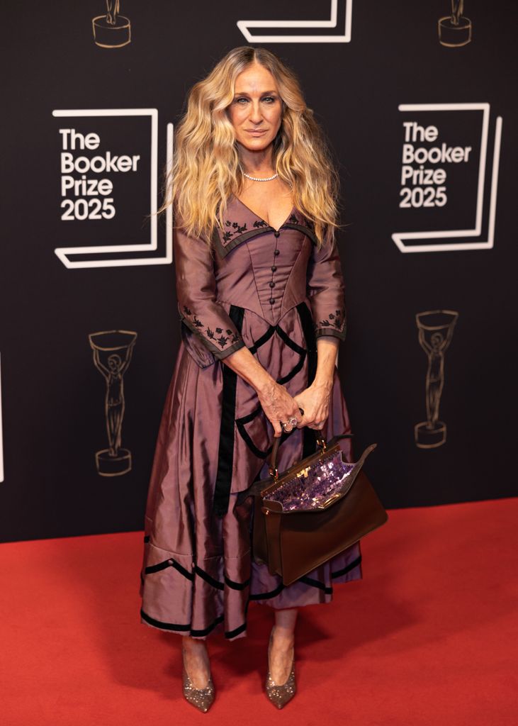 Sarah Jessica Parker on red carpet in mauve and black dress