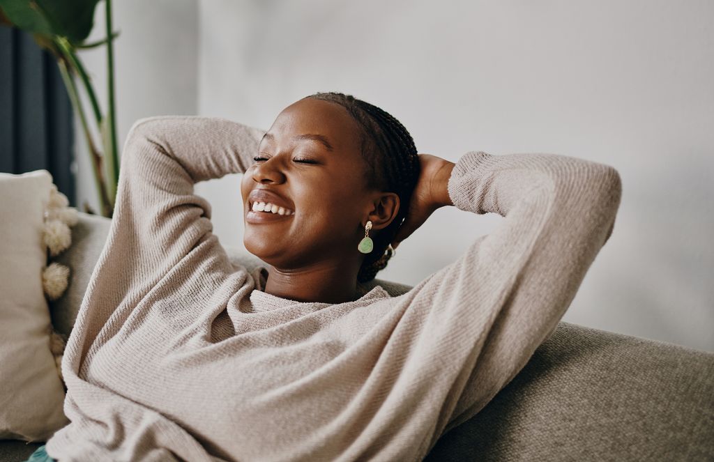 Shot of a young woman relaxing on the sofa at home