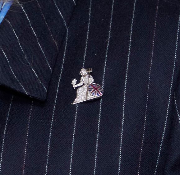 Queen Camilla's brooch on a pinstripe jacket