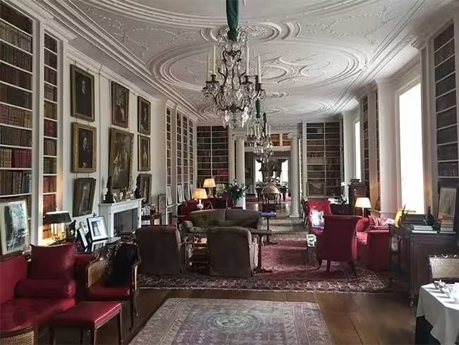 althorp house library with armchairs and rugs