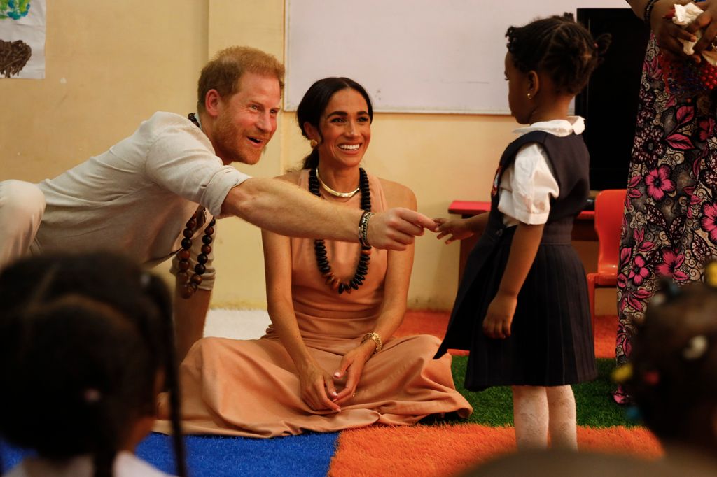 Prince Harry shakes hand with child