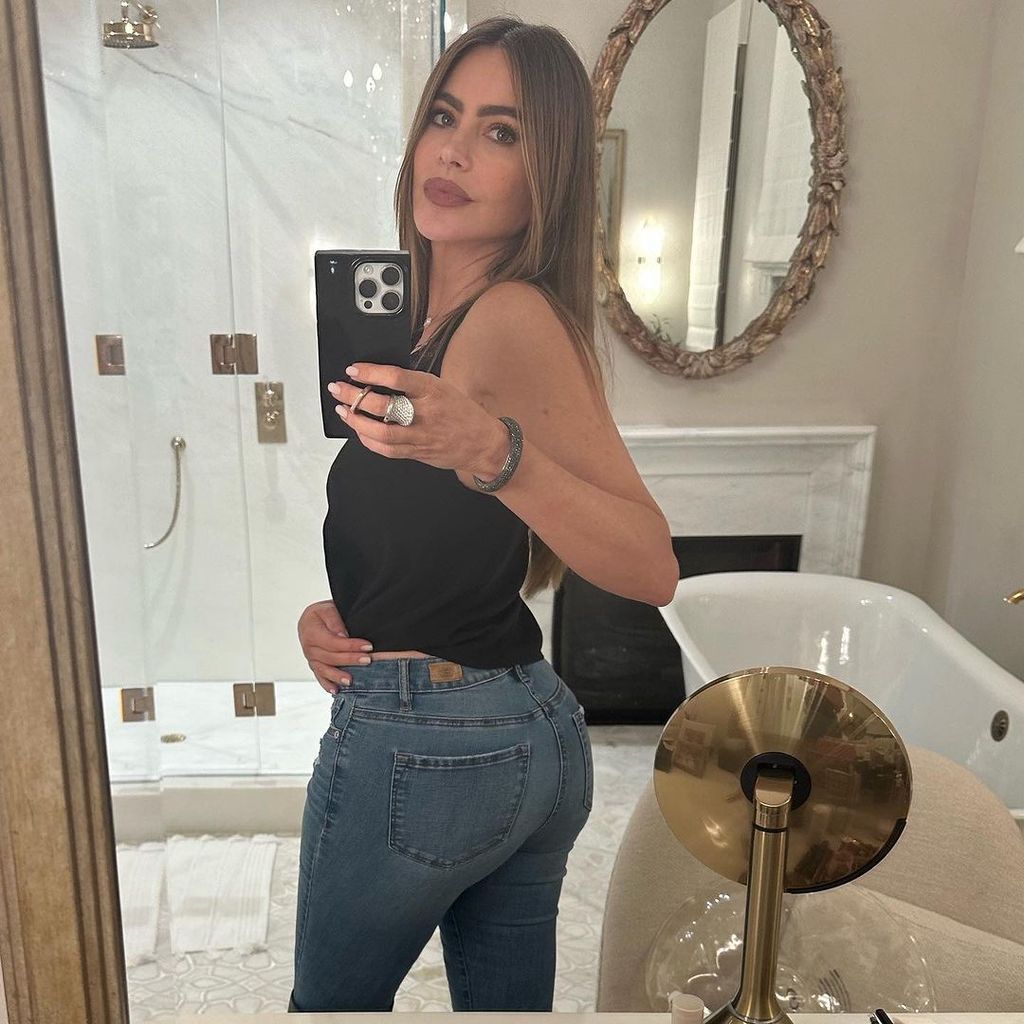 Sofia models her new jeans at her lavish home