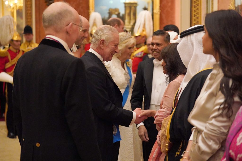 King Charles and Queen Camilla speaking with guests at Diplomatic reception