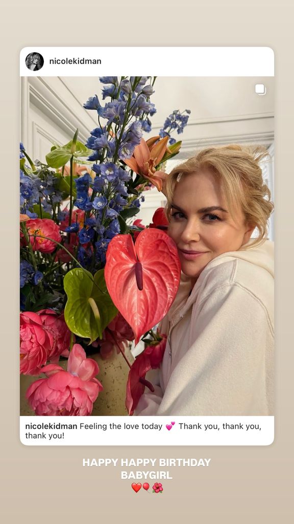 nicole kidman holding colorful flower arrangement