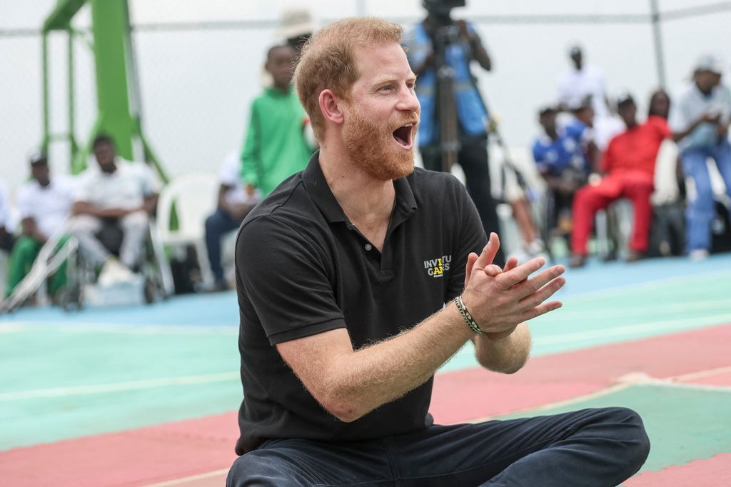 Prince Harry applauds as he takes part in a sitting volleyball match at Nigeria Unconquered