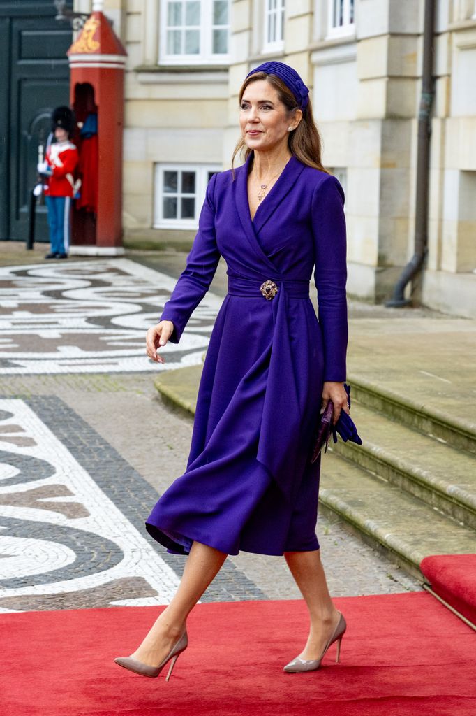 Queen Mary wearing purple dress and headband