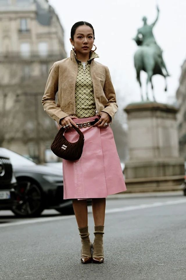influencer in pink leather midi skirt and suede jacket