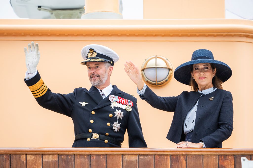 King Frederik and Queen Mary wave from the Royal Ship Dannebrog