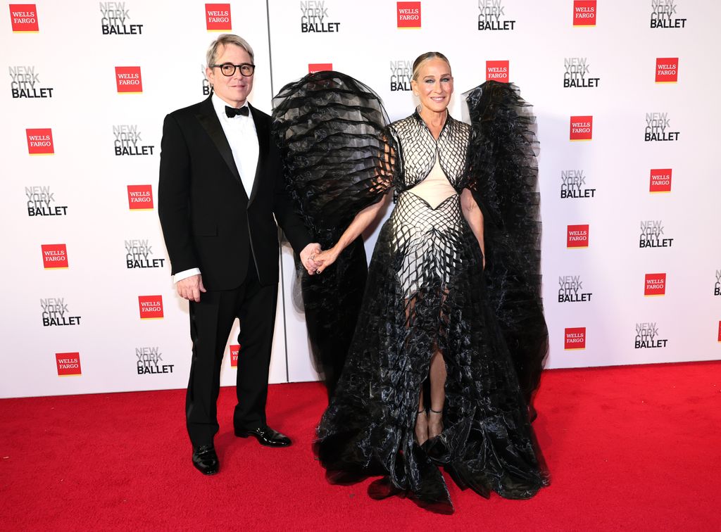 Matthew Broderick in black tie and Sarah Jessica Parker in winged dress on red carpet 