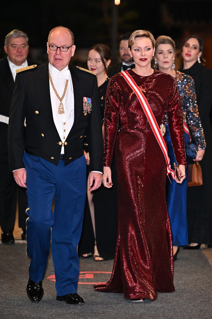 Prince Albert II of Monaco and Princess Charlene of Monaco in red arrrive at a Gala 