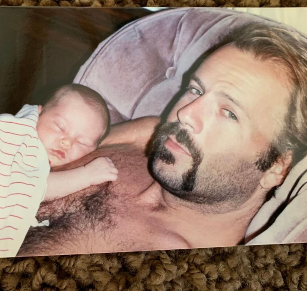 Throwback photo shared by Rumer Willis on Instagram December 2023 where she is pictured as a newborn sleeping on her dad Bruce Willis' chest.