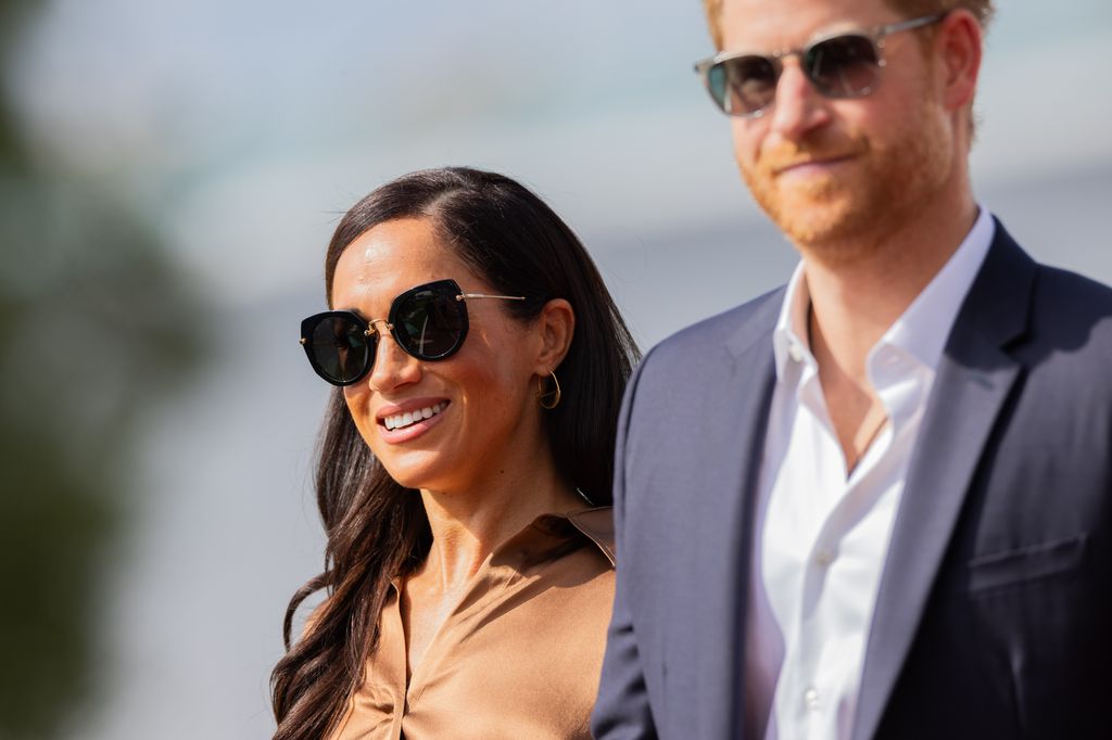 Meghan Markle walking with sunglasses on