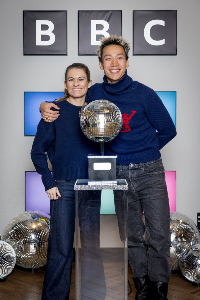 Carlos Gu standing with his arm around Karen Carney with the pair behind the Glitterball