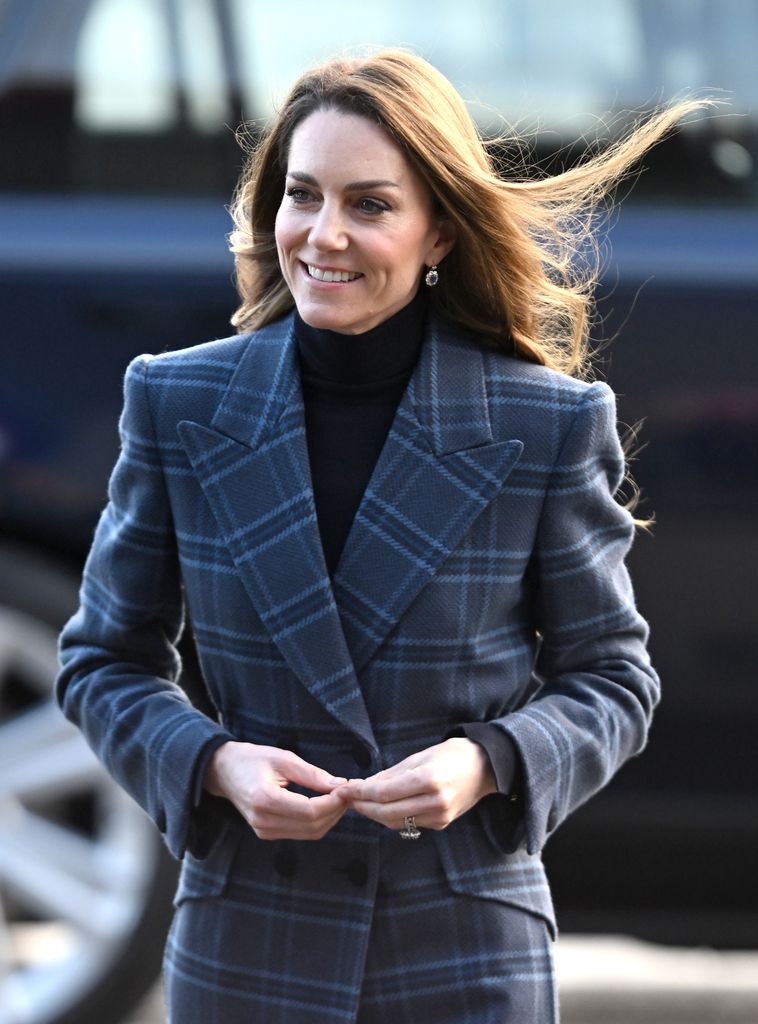 Catherine, Princess of Wales smiling in blue tartan coat