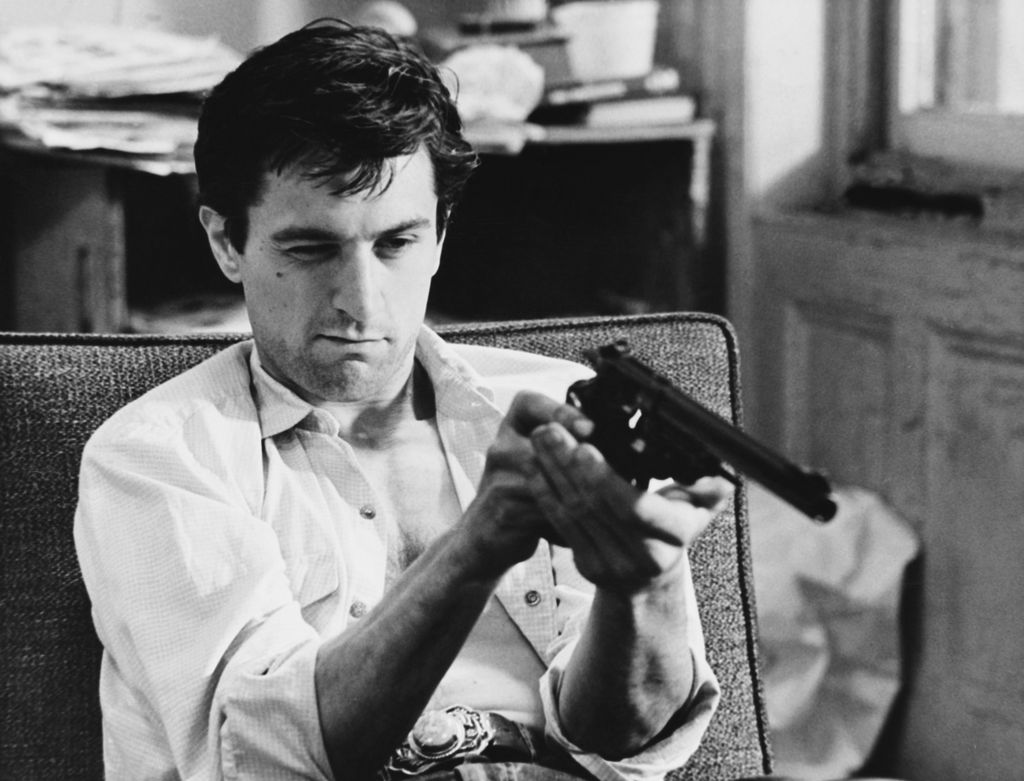 Travis Bickle (Robert De Niro) checks out his revolver in the movie Taxi Driver.