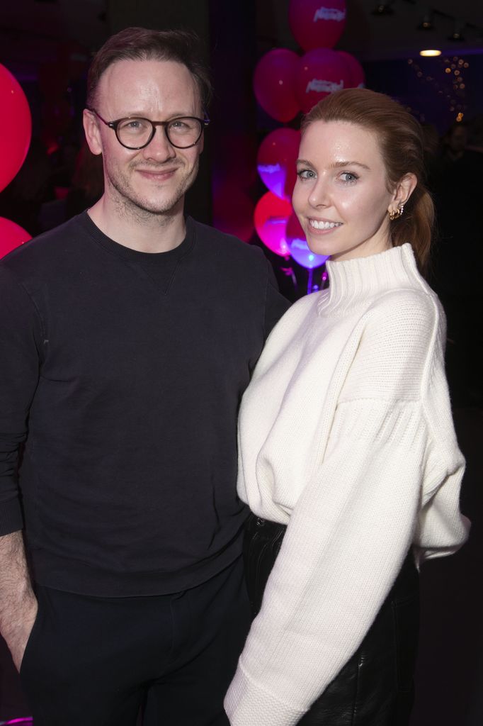 Kevin Clifton in a black jumper standing with Stacey Dooley in a white turtleneck