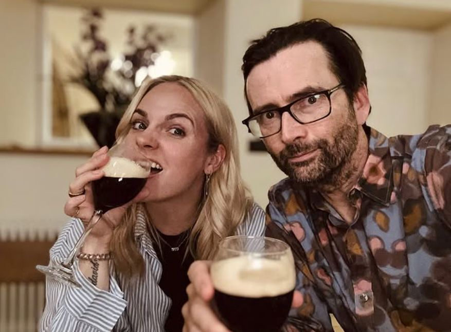 Georgia Tennant and David Tennant with glasses of alcohol