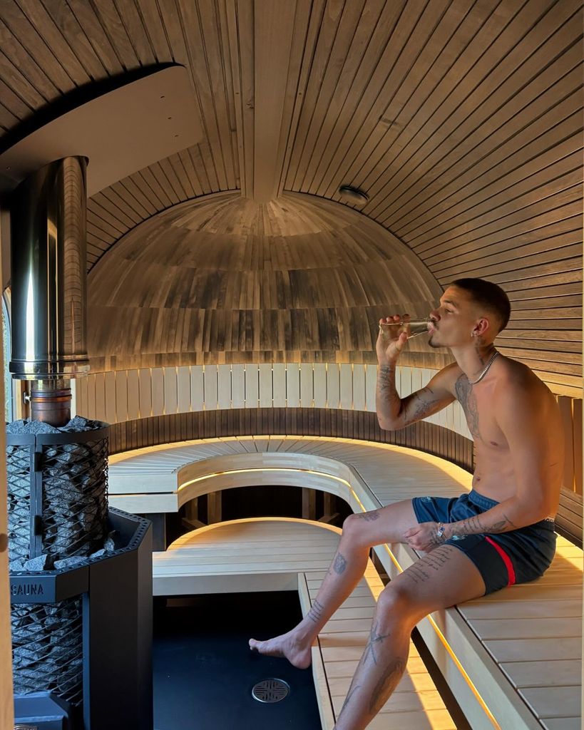 Romeo Beckham sits in a suana and sips on Champagne