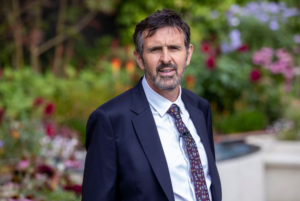 adam frost in suit and tie in garden