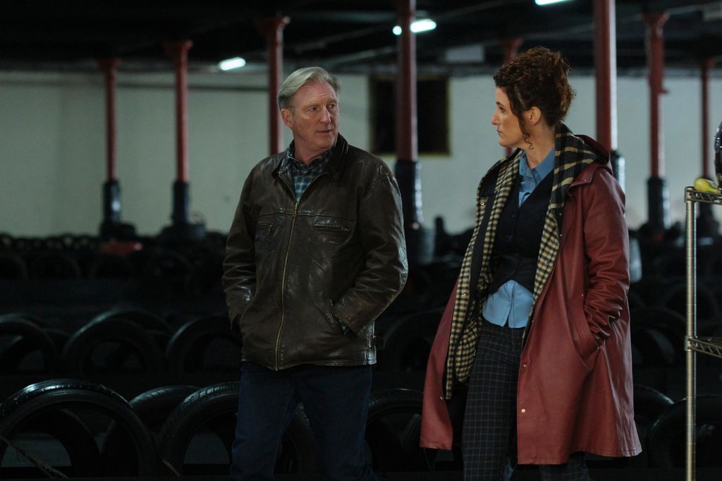 man and woman walking in dimly lit room